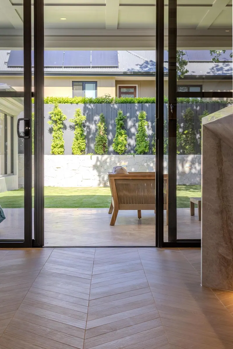 Herringbone timber floor and garden-facing sliding doors